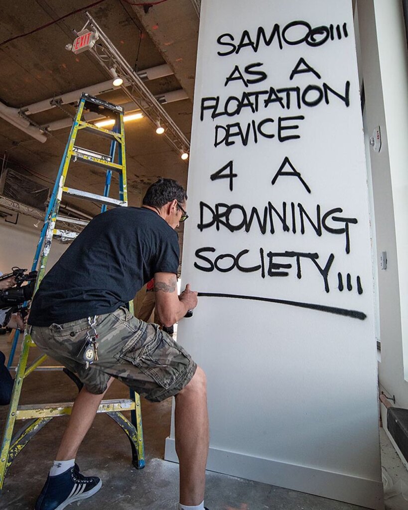Al Diaz aka Samo in action enhancing the walls at Beyond the Streets Photo Courtesy of ©Martha Cooper