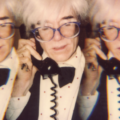 Paige Powell Andy Warhol on the telephone in his tiny office at his studio Con Edison building New York City
